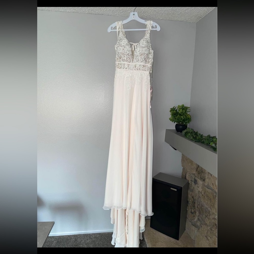 NWT-wedding dress. New, never worn, tags still on it, non-altered, ivory, size 4